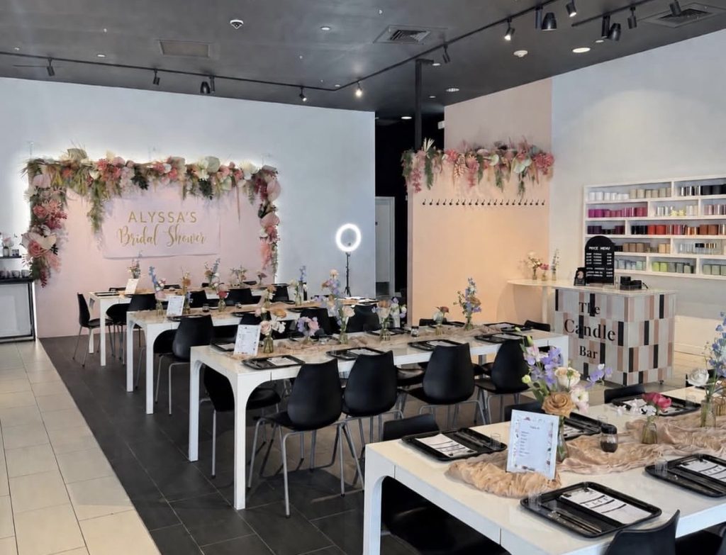 The Blank Mason party room styled for a bridal shower, with long tables and a flower wall