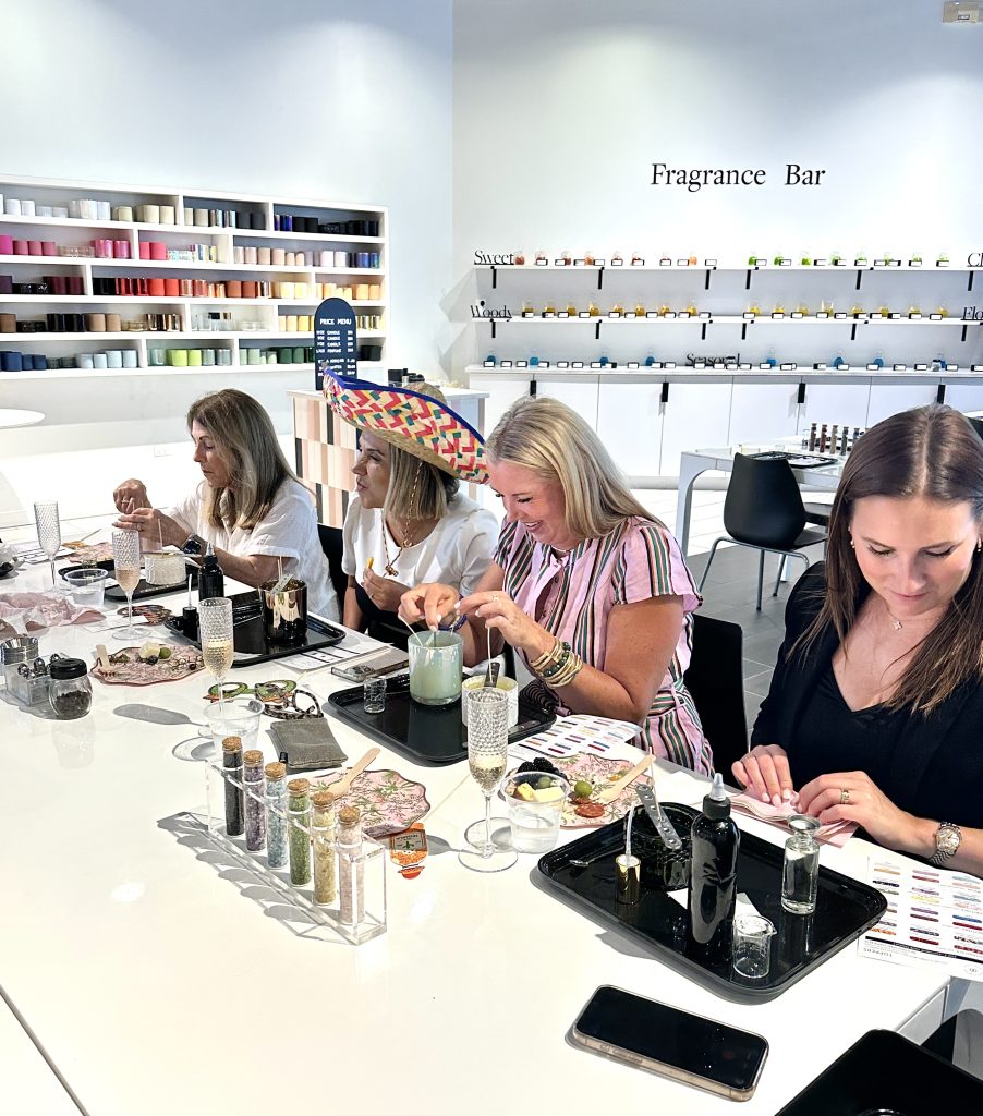 Bachelorette party guests making candles together at the Blank Mason candle bar